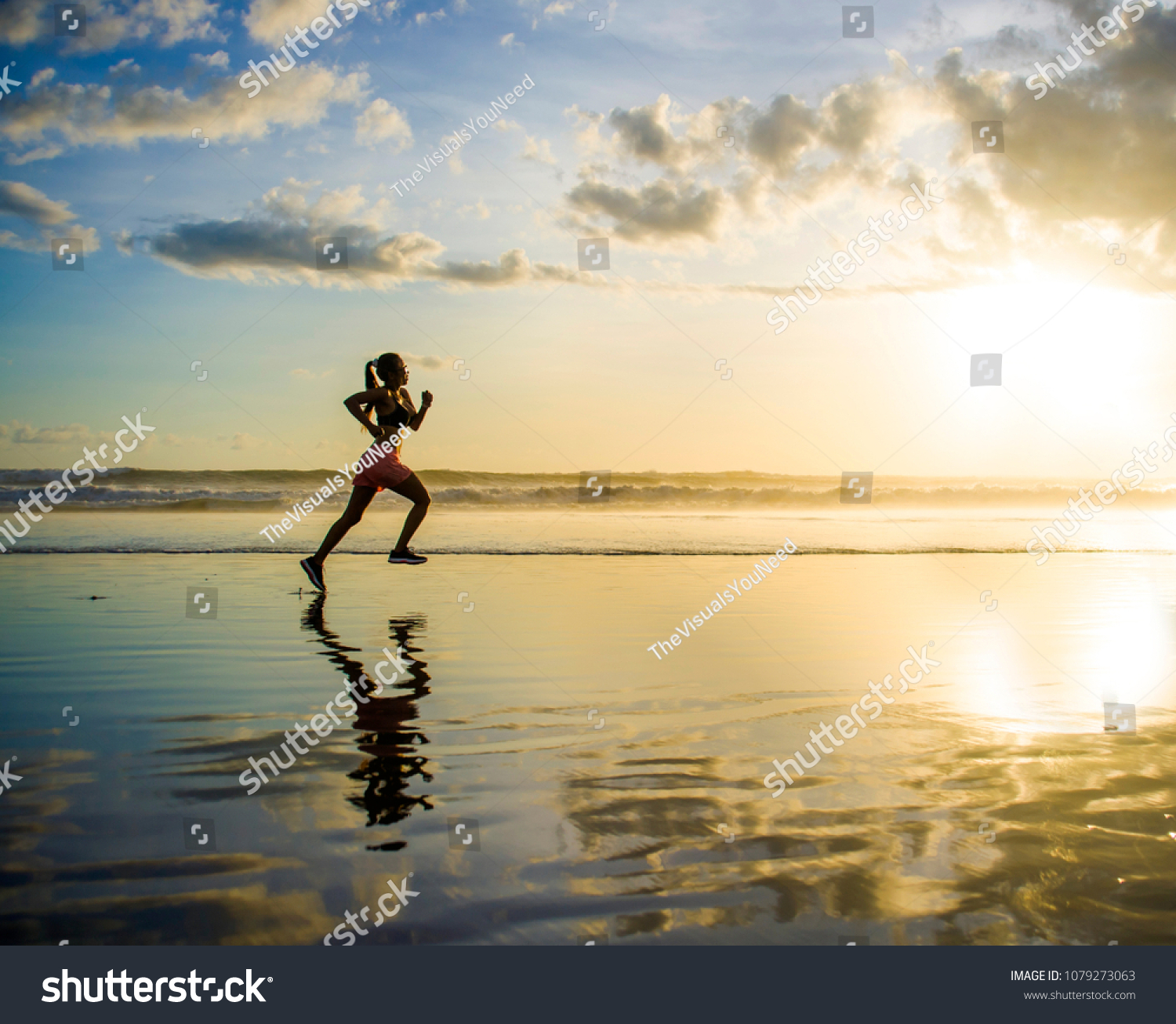 silhouette of young woman in running workout training at sunset beach