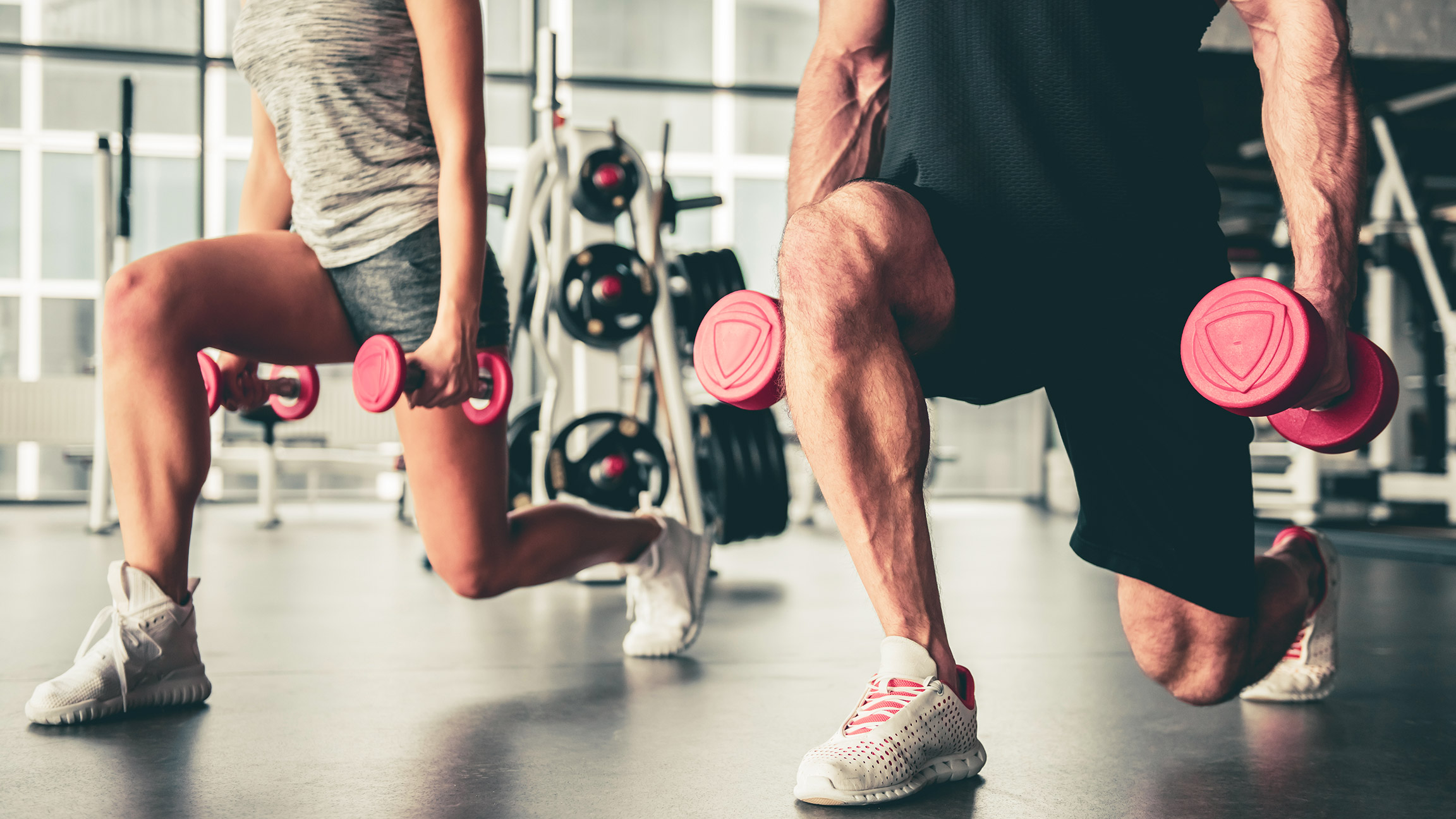 male and female working out in gym