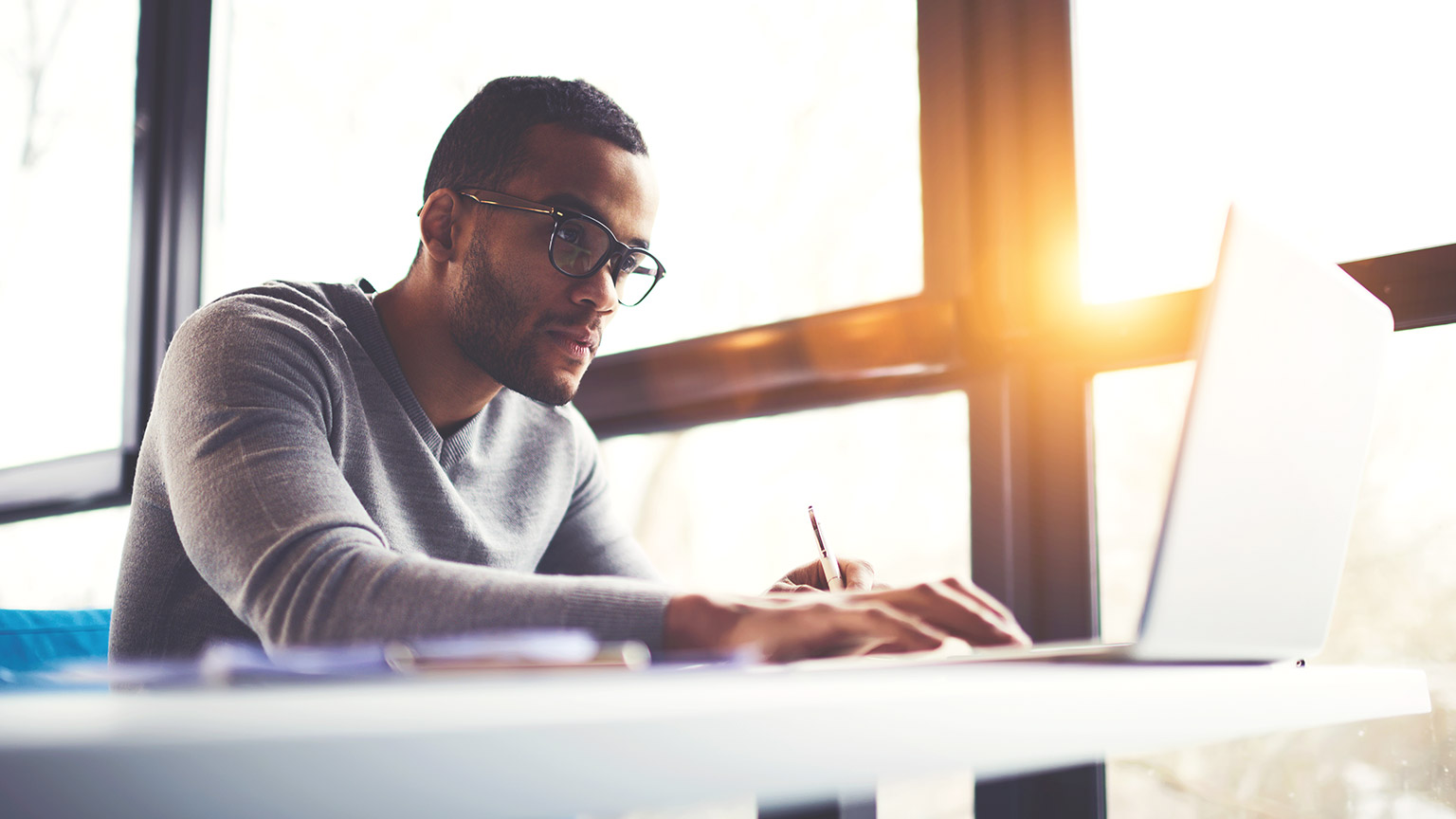 Young male designer working as a desk