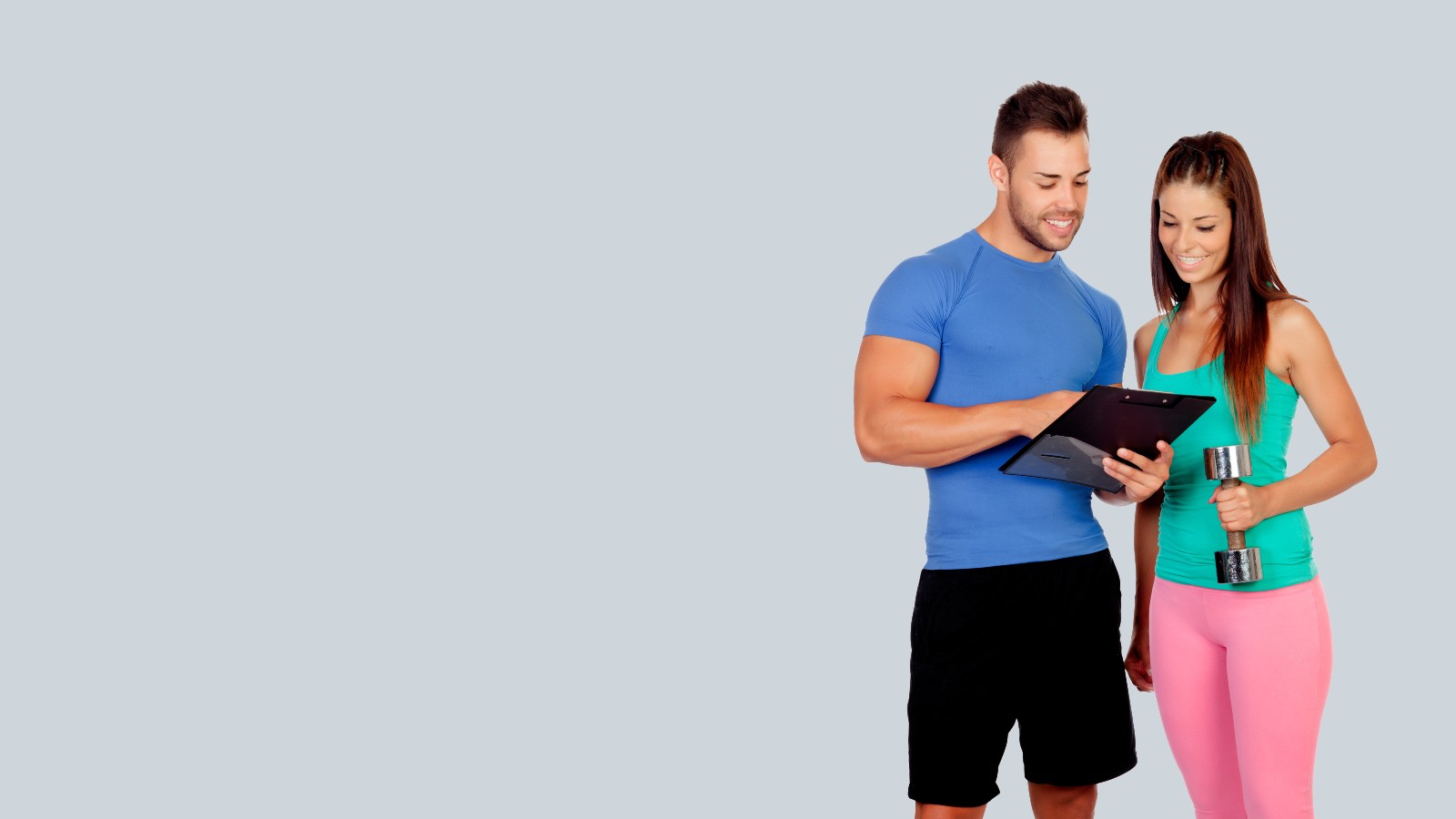 Man and a Woman in Fitness Attire Looking At Clipboard