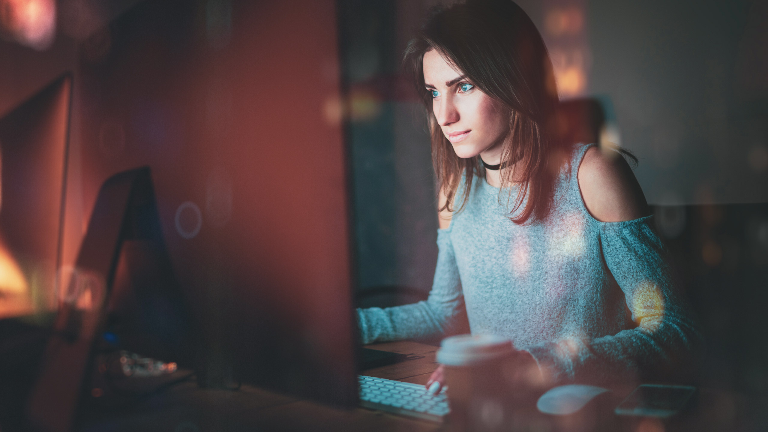 Female designer working at a desktop computer