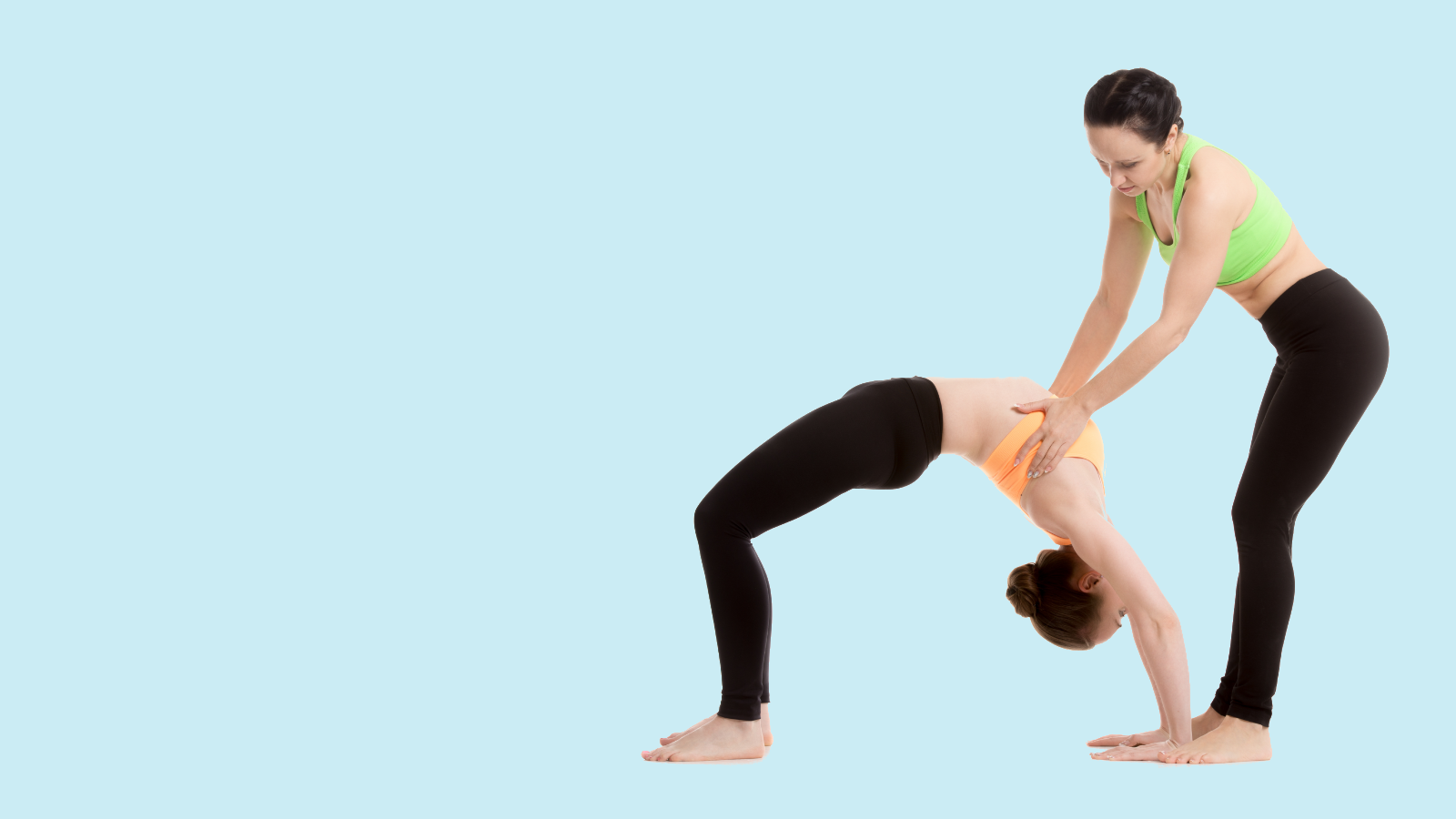 Yoga Instructor Assisting a Student 