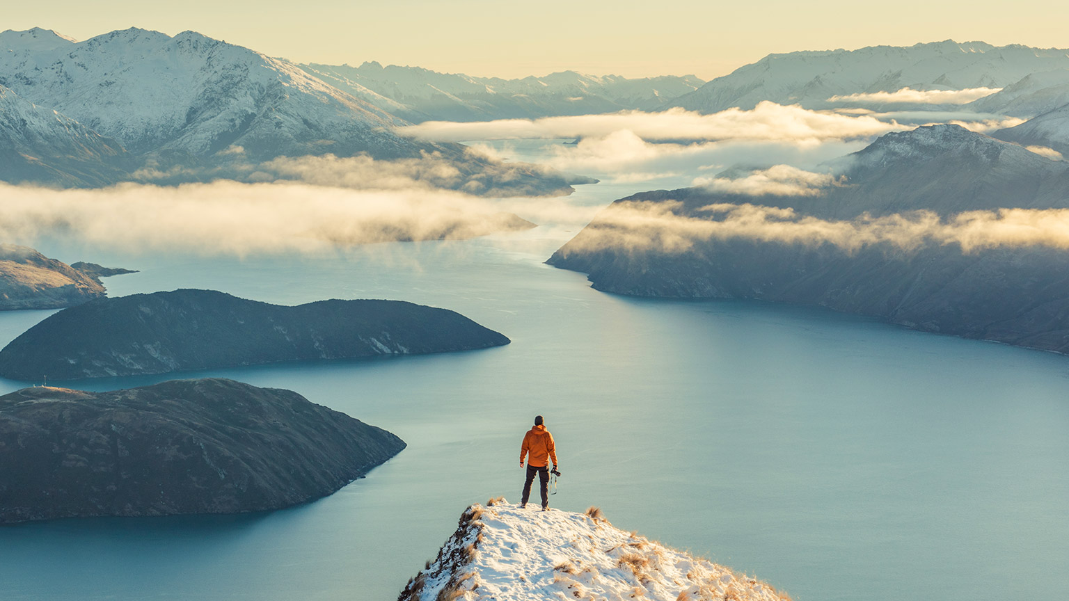 Man standing on Roy's Peak admiring view over Lake Wanaka