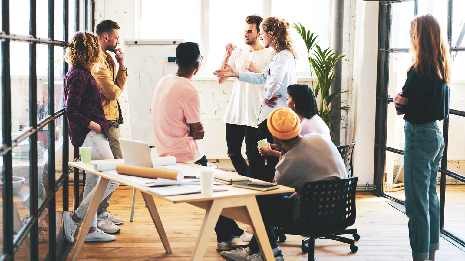 Group of professionals in a meeting room discussing marketing strategy