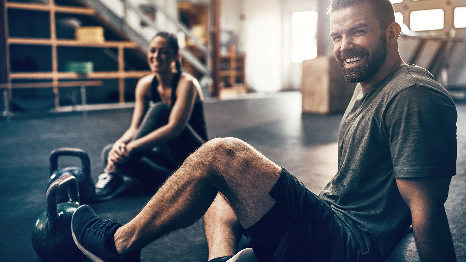 Relaxed man and woman in a gym