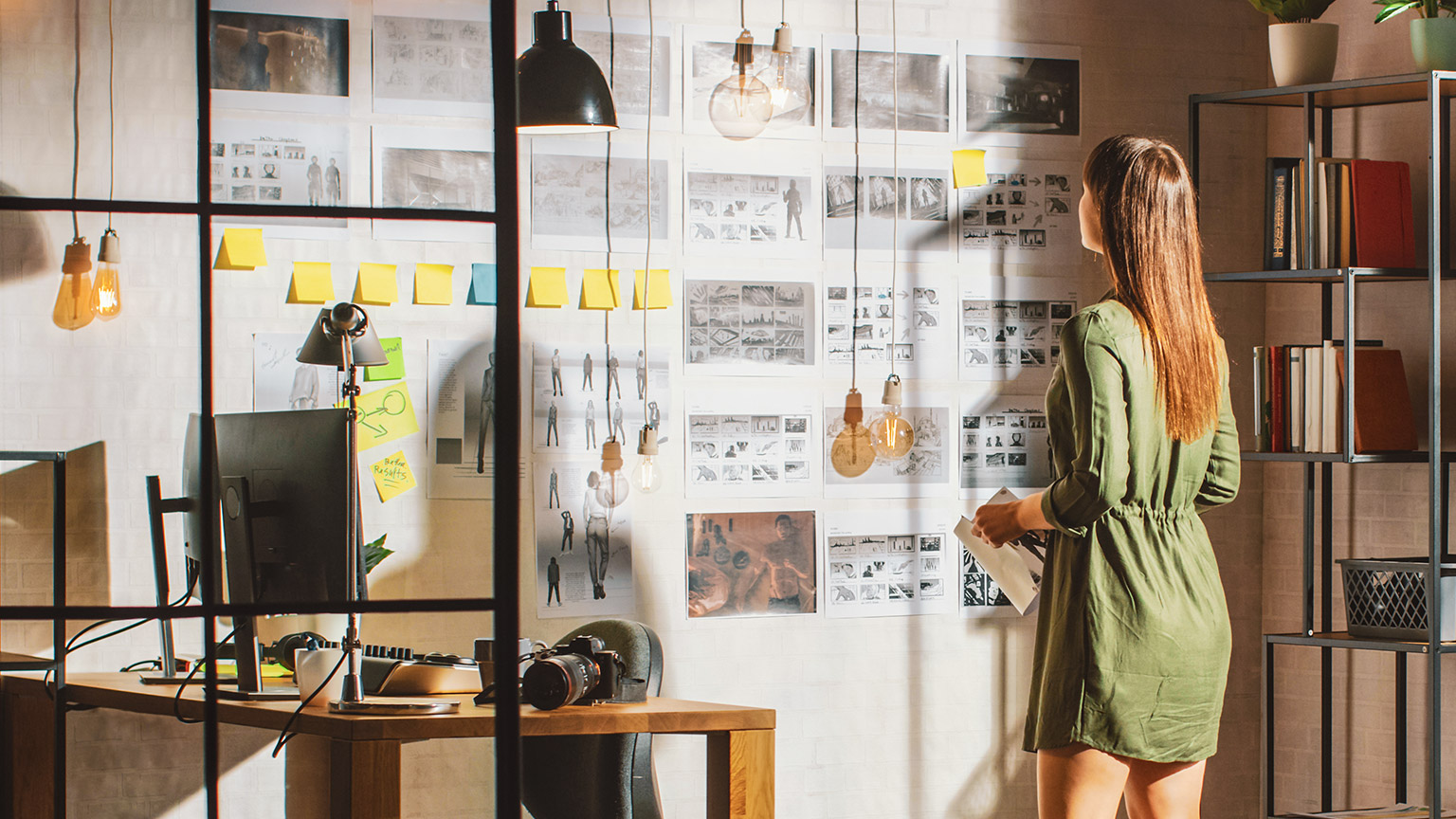 Woman looking at storyboards on a wall