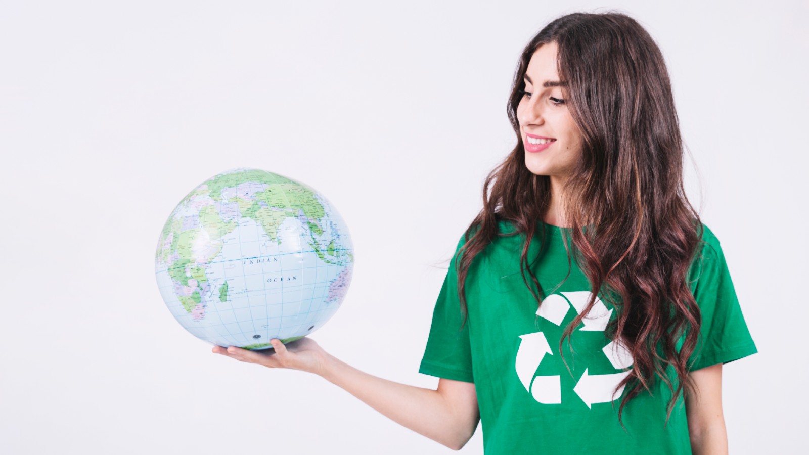 Woman wearing a recycling shirt and holding a world globe