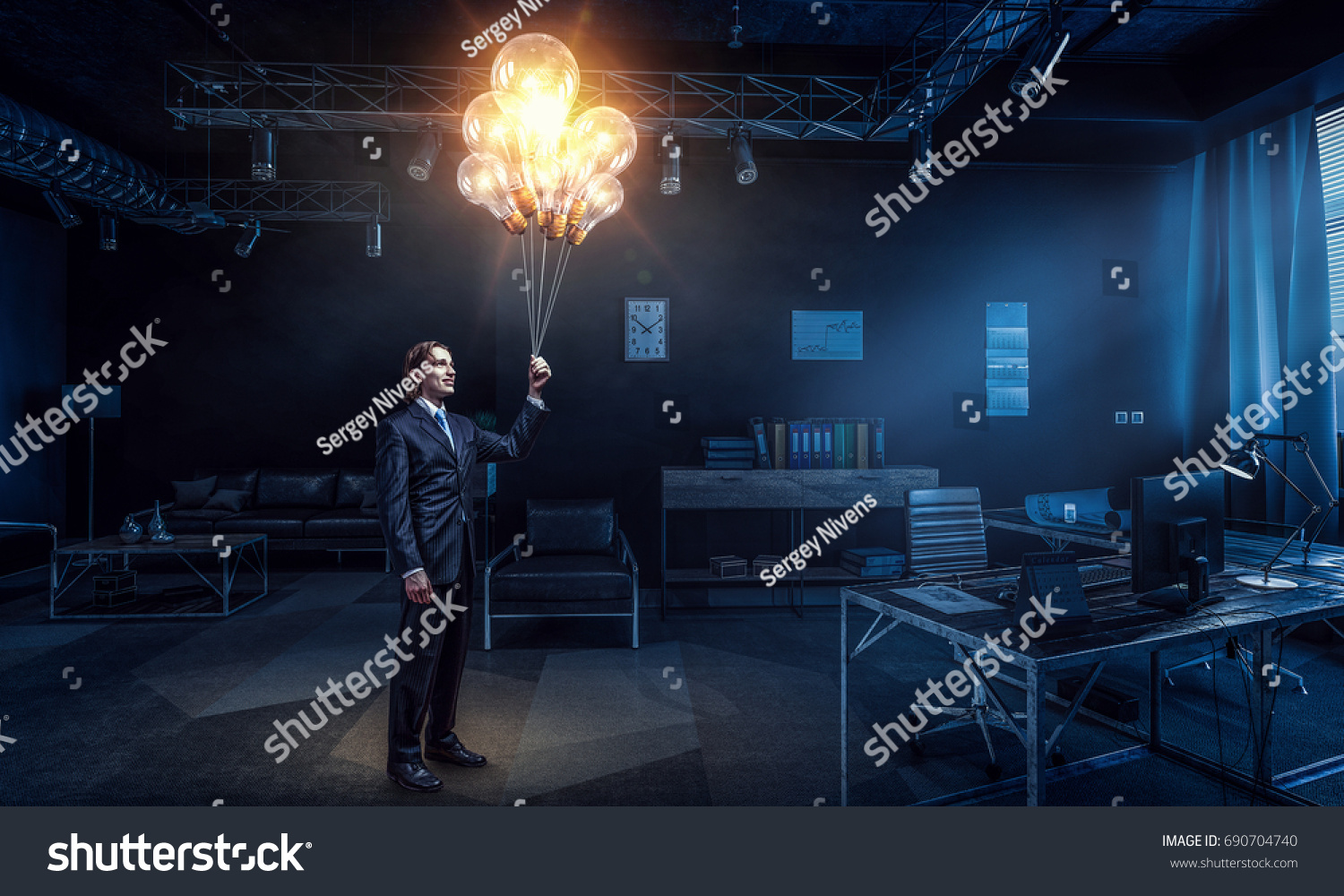 Man in business suit holding light bulbs