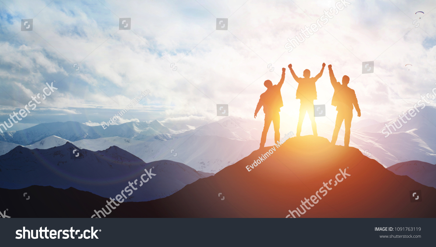 Silhouette of the team on the mountain. 