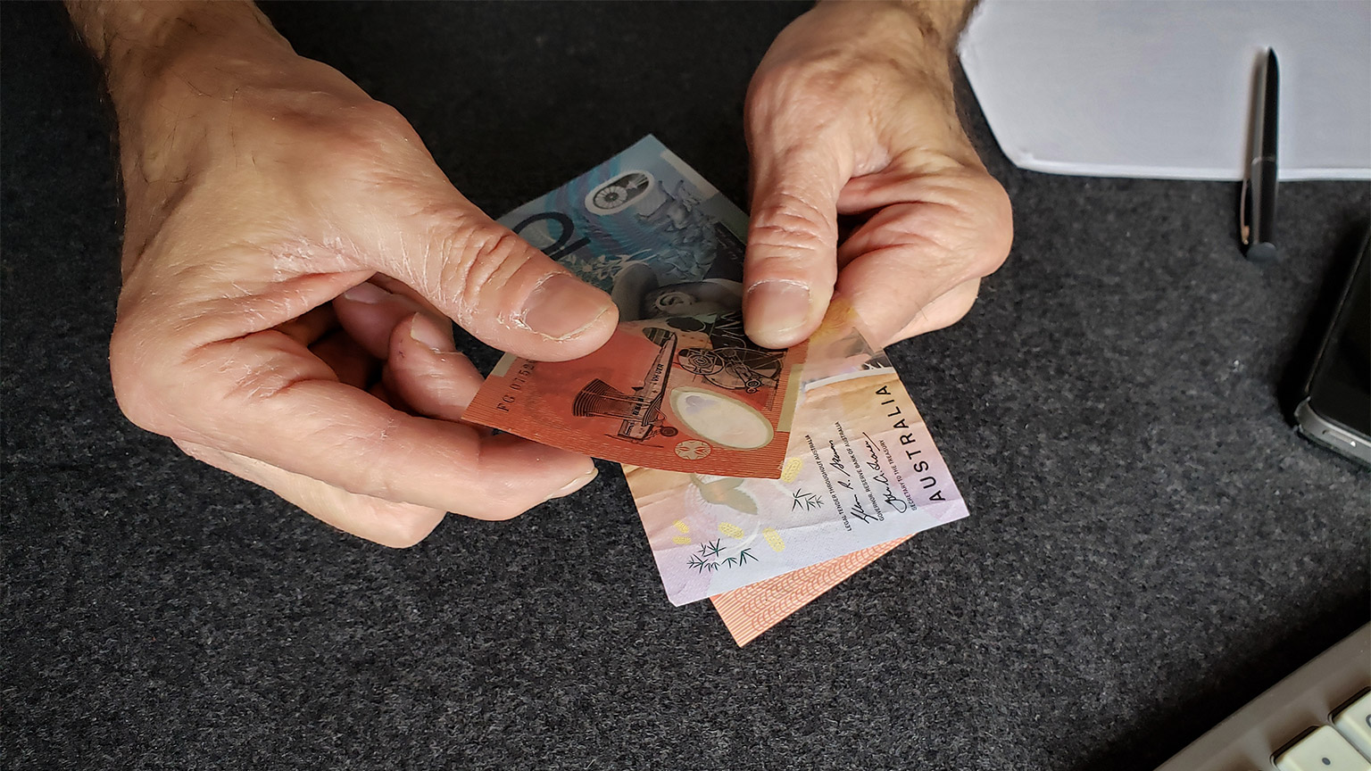 Counting out Australian banknotes