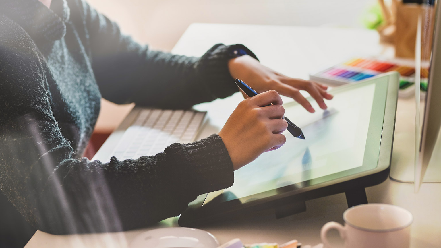 Female illustrator working on desktop computer