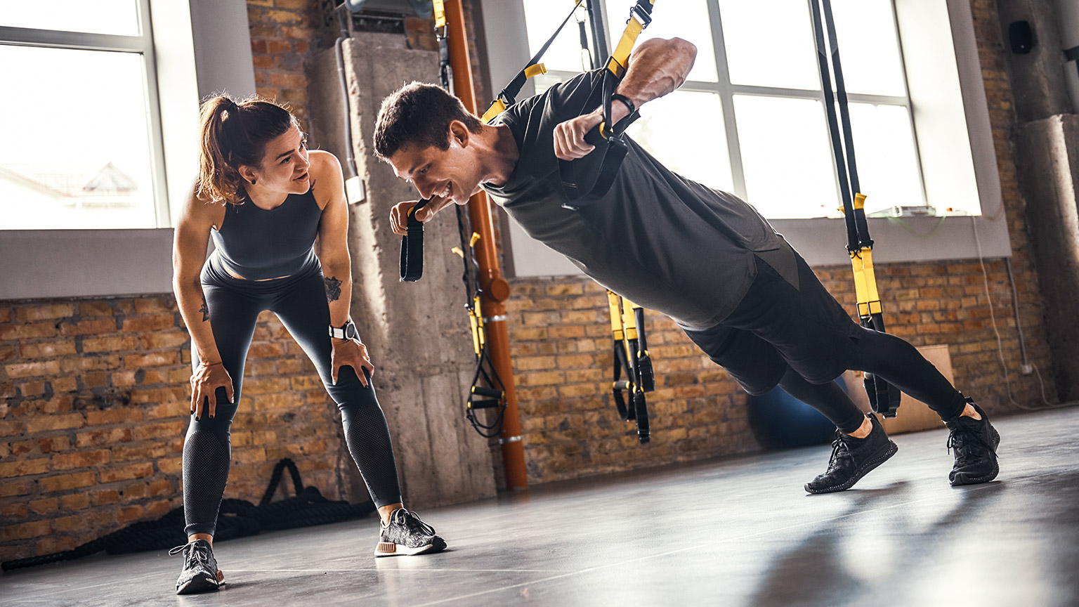 Female trainer motivating client