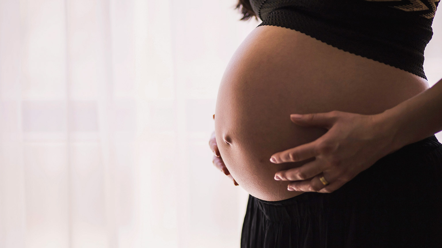 Pregnant woman holding stomach