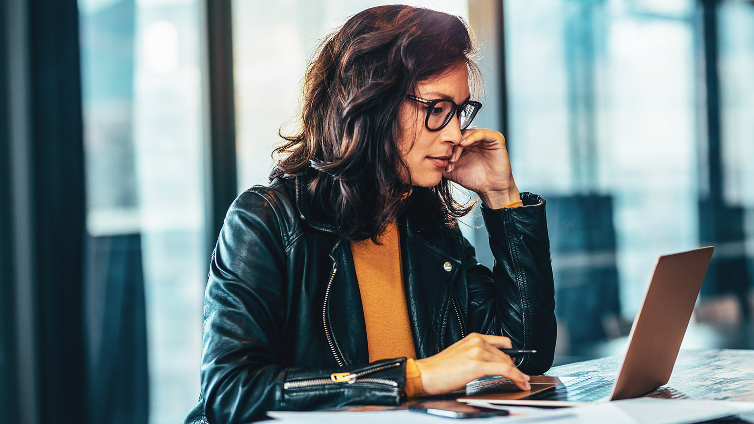 Woman at desk working on a laptop