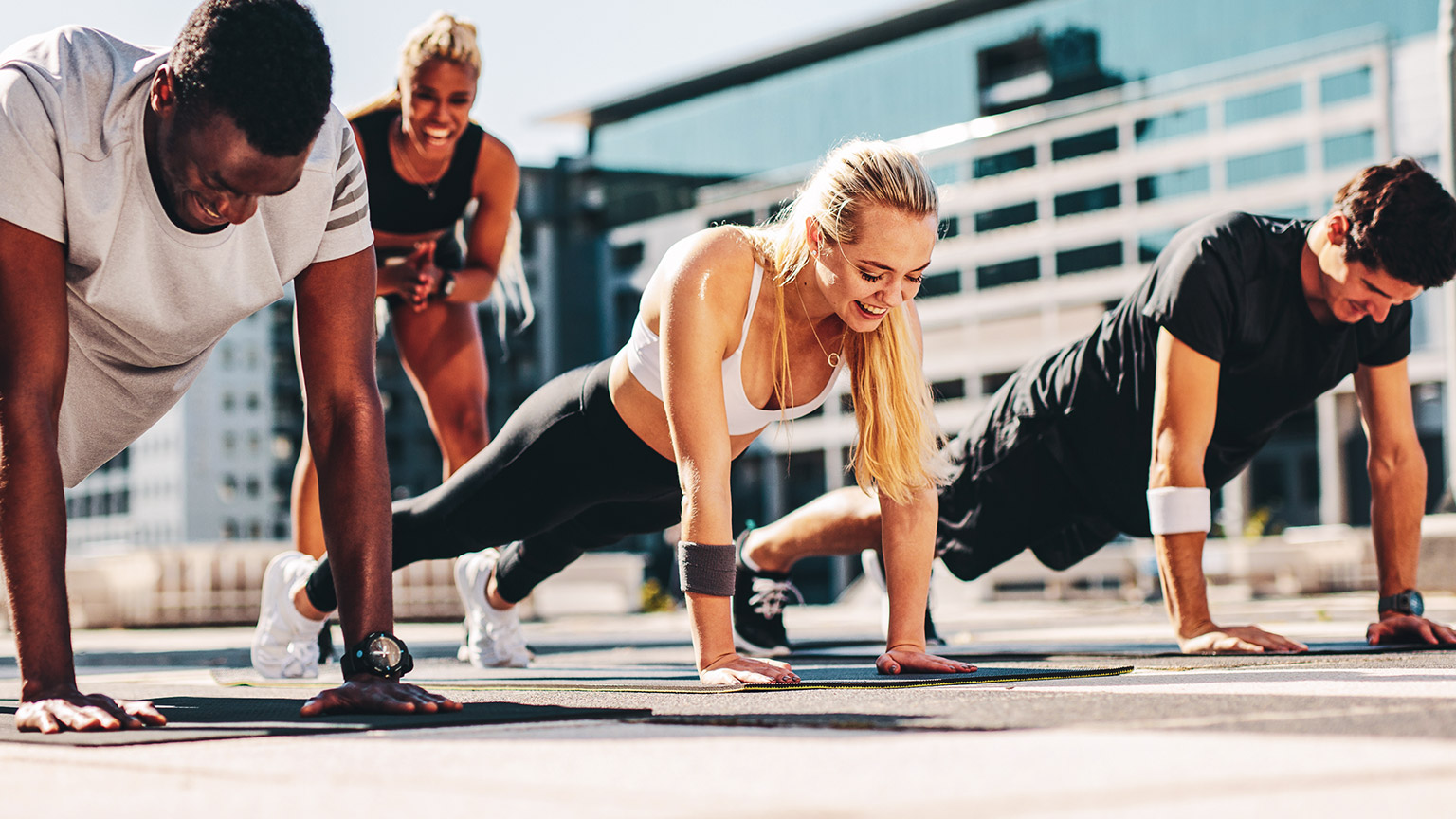 An exercise class working out outdoors