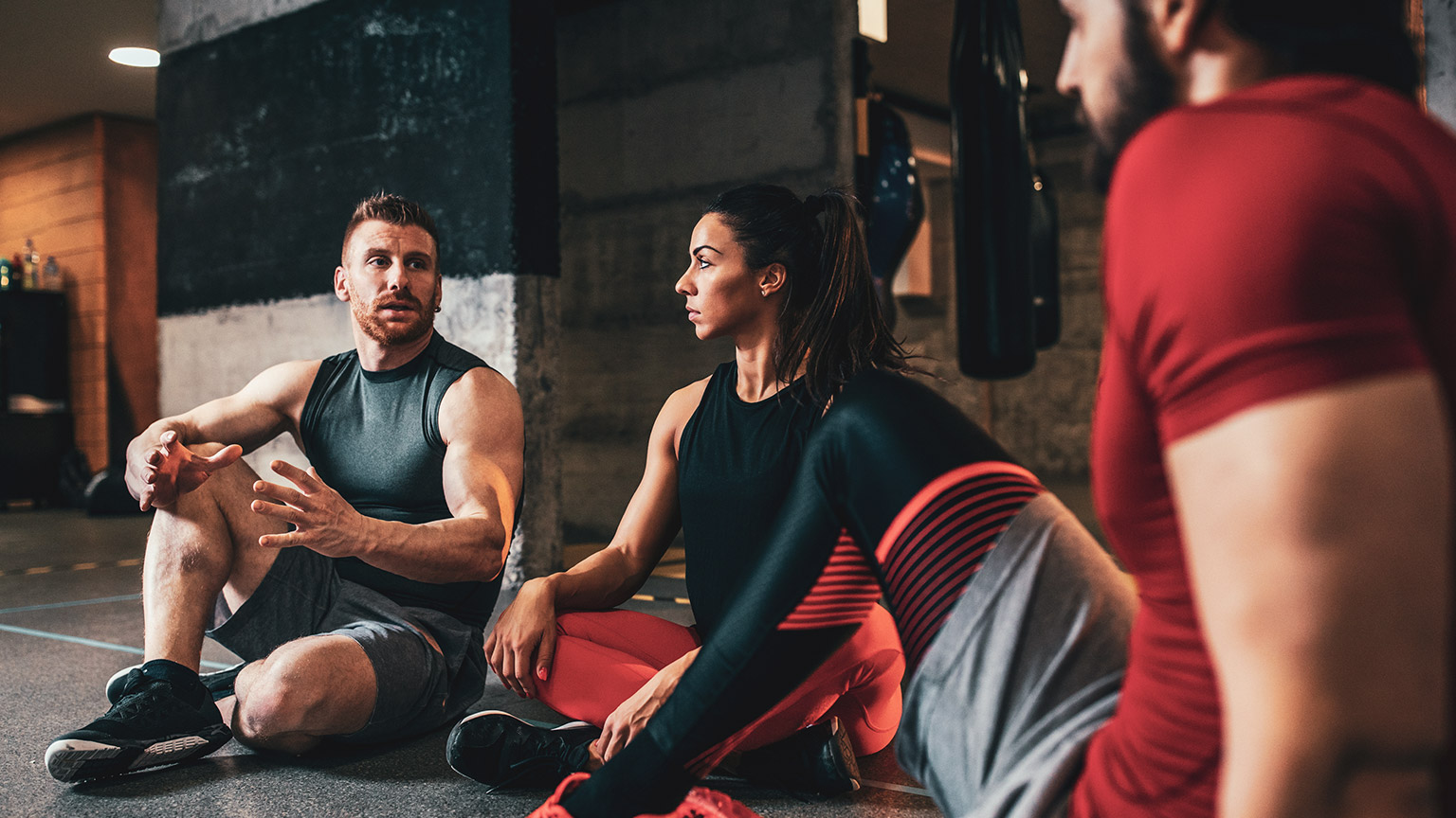 A group of employees at a gym discussing WHS related matters