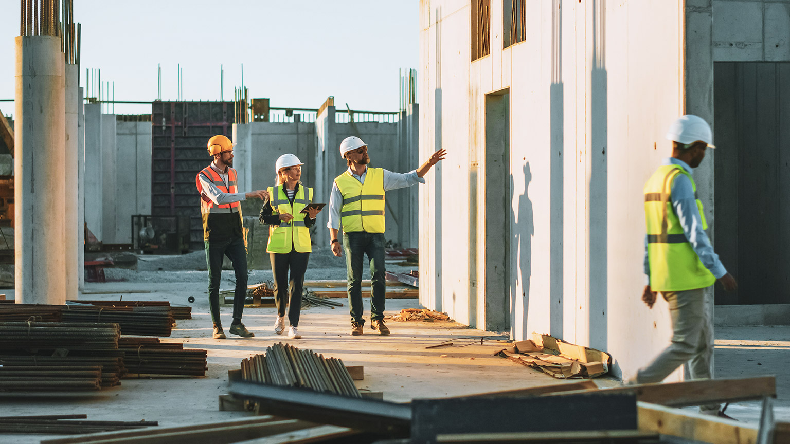 A group of construction managers checking the progress of a large construction project