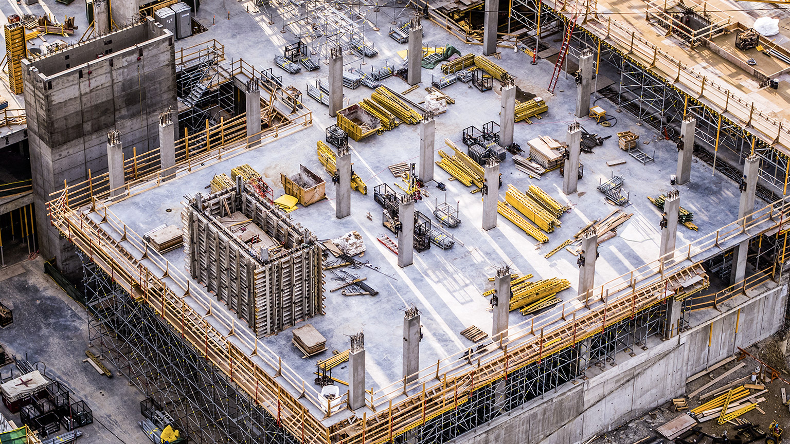 An aerial view of scaffolding on a busy industrial construction site