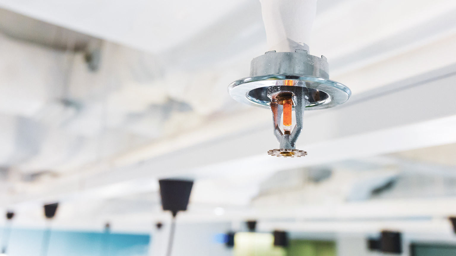 A close view of a fire suppresant device on the ceiling