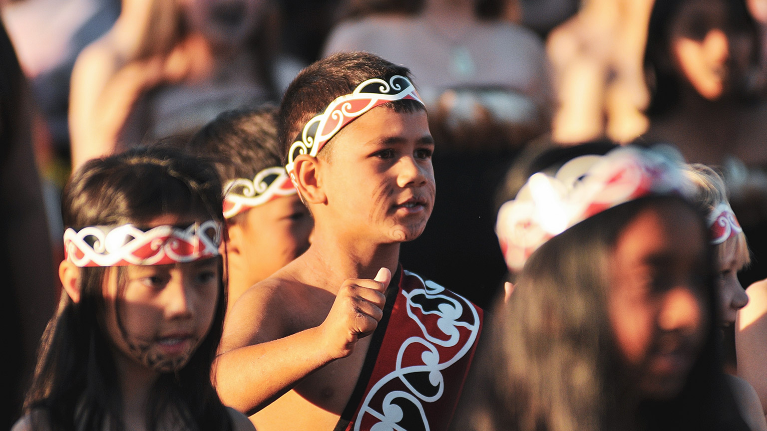 A group of young people participating in a Maori cultural event