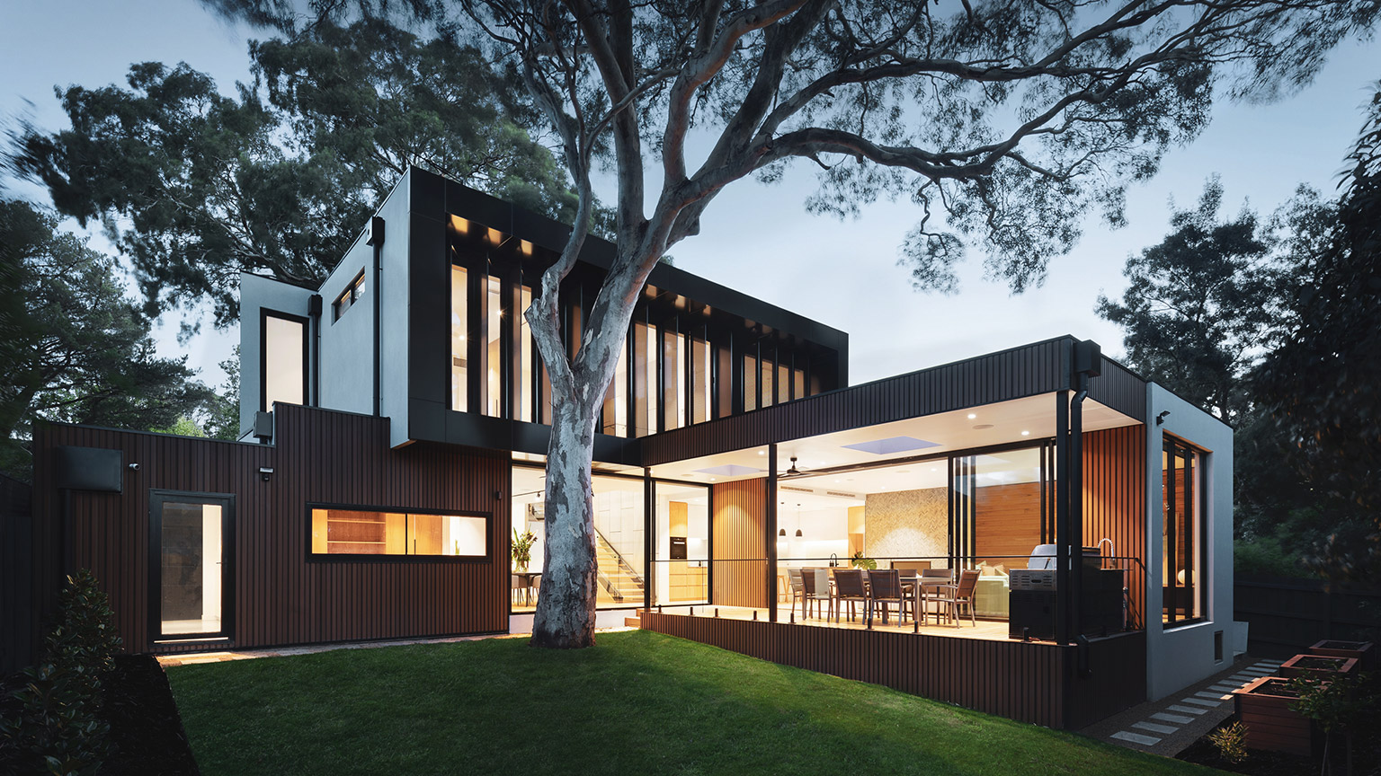 An exterior view of a modern suburban dwelling at dusk