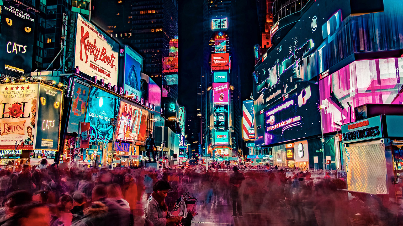 A long exposure night view of a busy times square