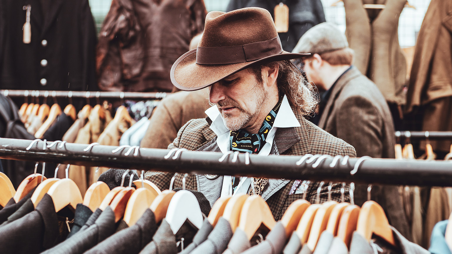 A hipster shopping in a boutique for more hipstery clothing