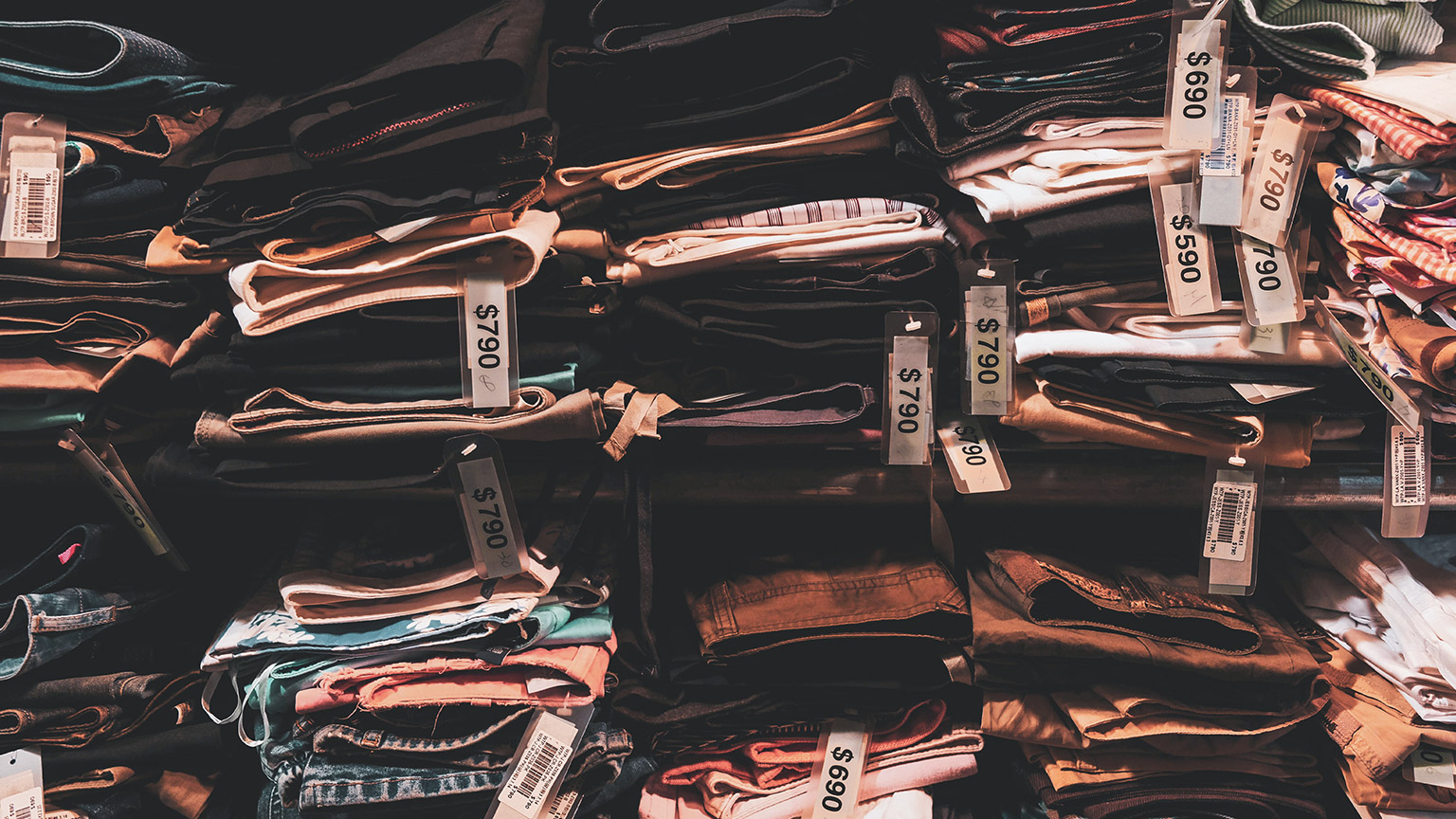 A shelf of expensive clothing in a high-end shop