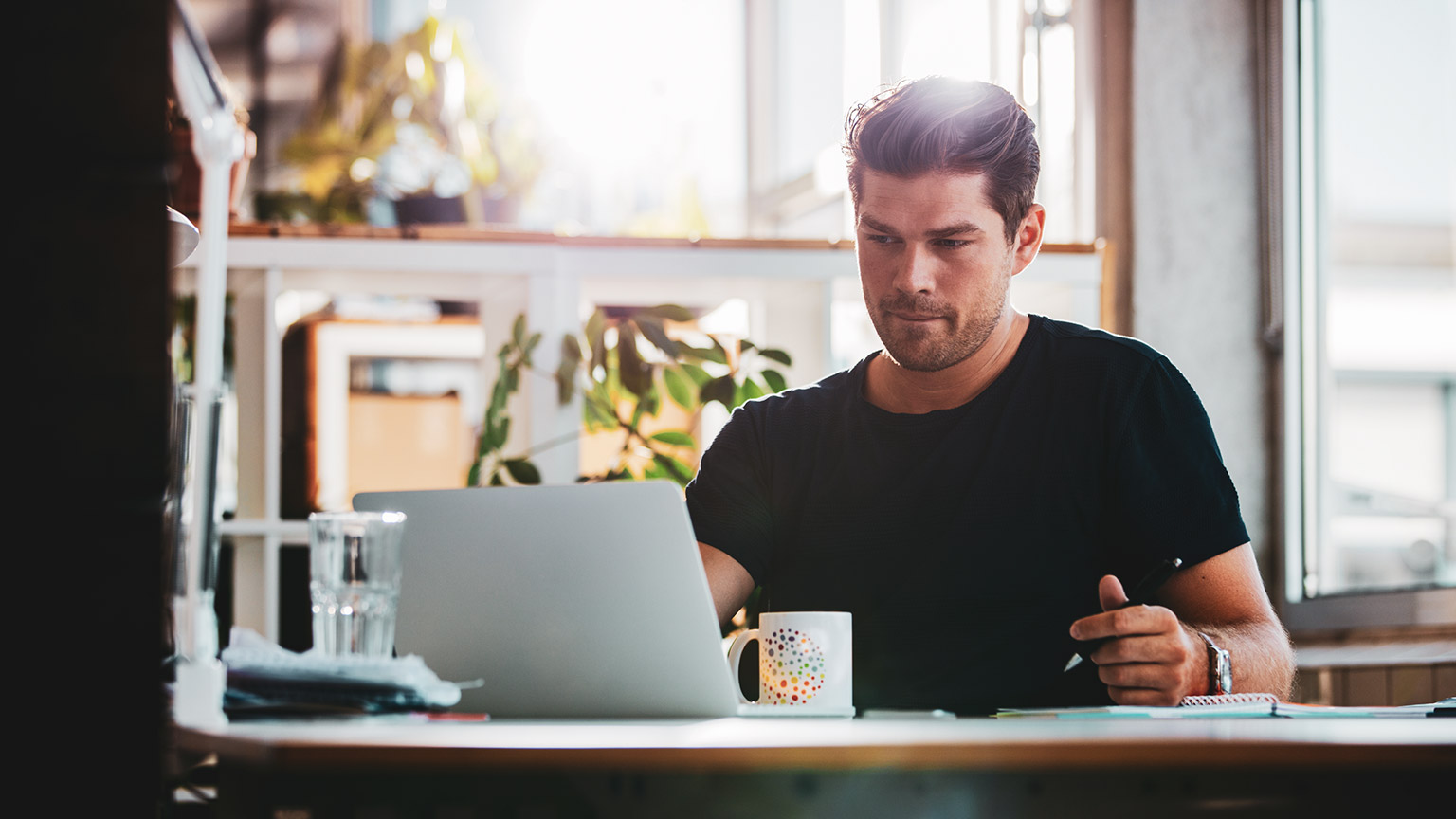 An accountant sitting at a desk working on a laptop