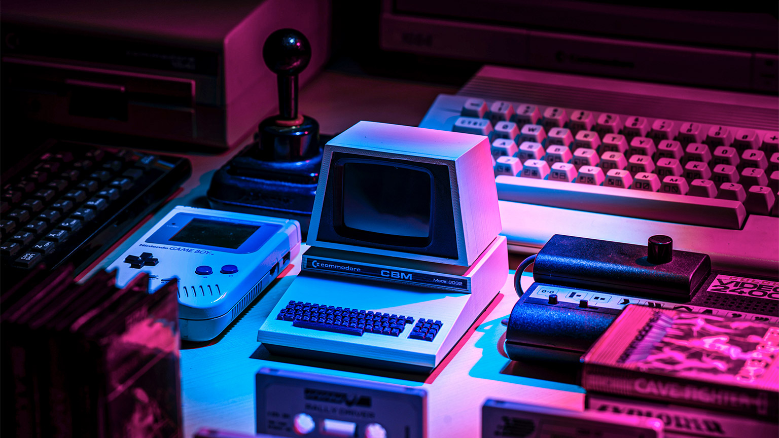 A collection of vintage gaming consoles, cartridges and joysticks