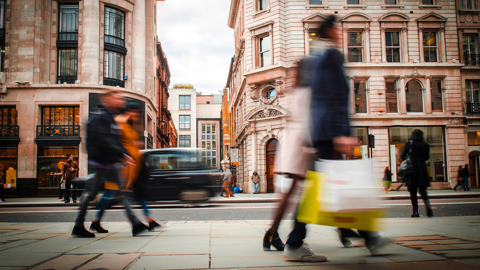 A view of a busy street with shoppers walking past