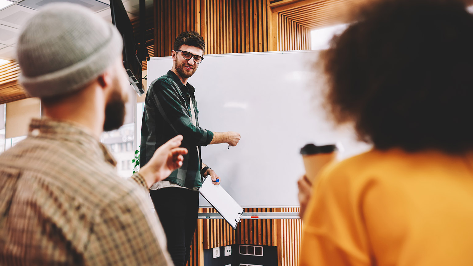 A youth worker talking to other youthworkers about a project plan