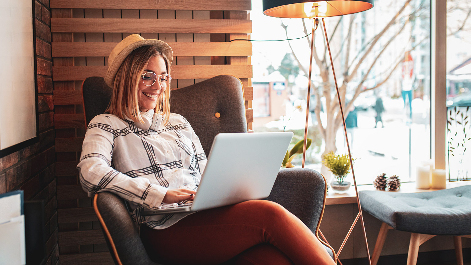 A young energetic designer working on a laptop in a relaxed office environment