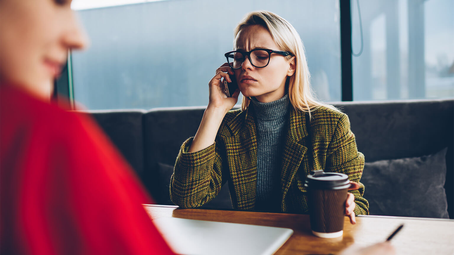 An entrepreneur taking a call during a meeting, handling a stressful situation that's arisen