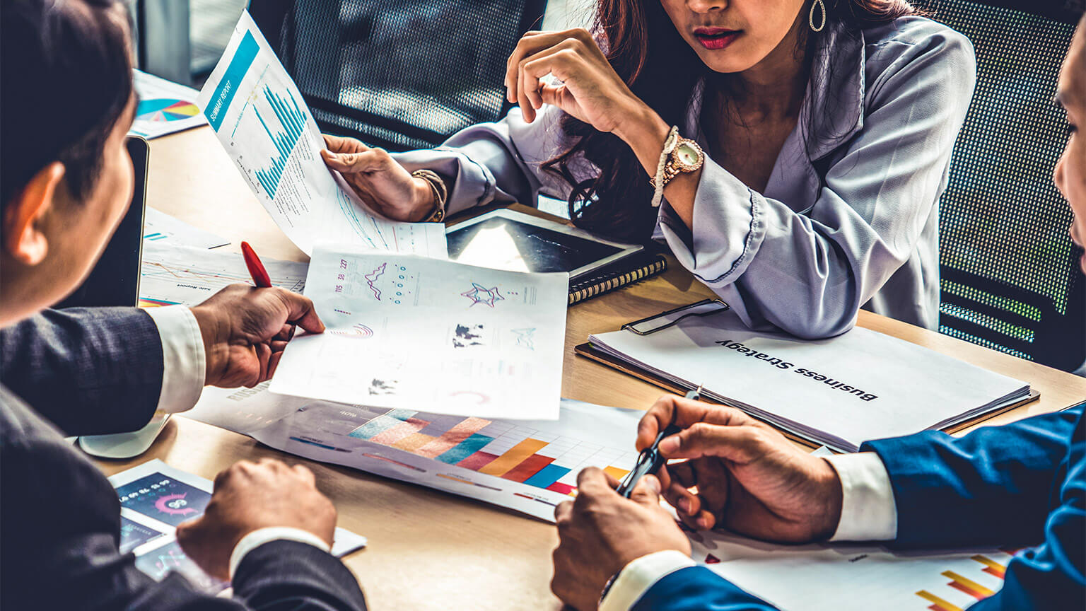 The owners of an organisation reviewing data visualisations, conveying the financial situation of their business