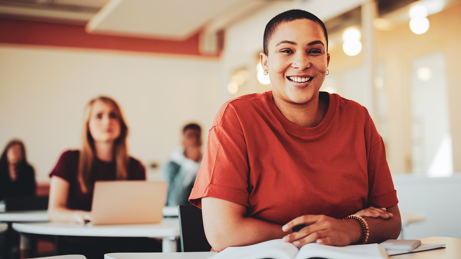 A youth worker sitting at a desk in a room