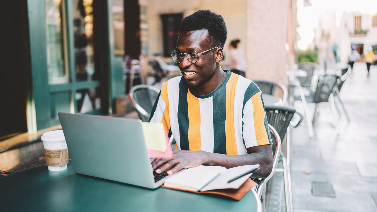 A young designer having an enjoyable interaction with a website in an outdoor environment