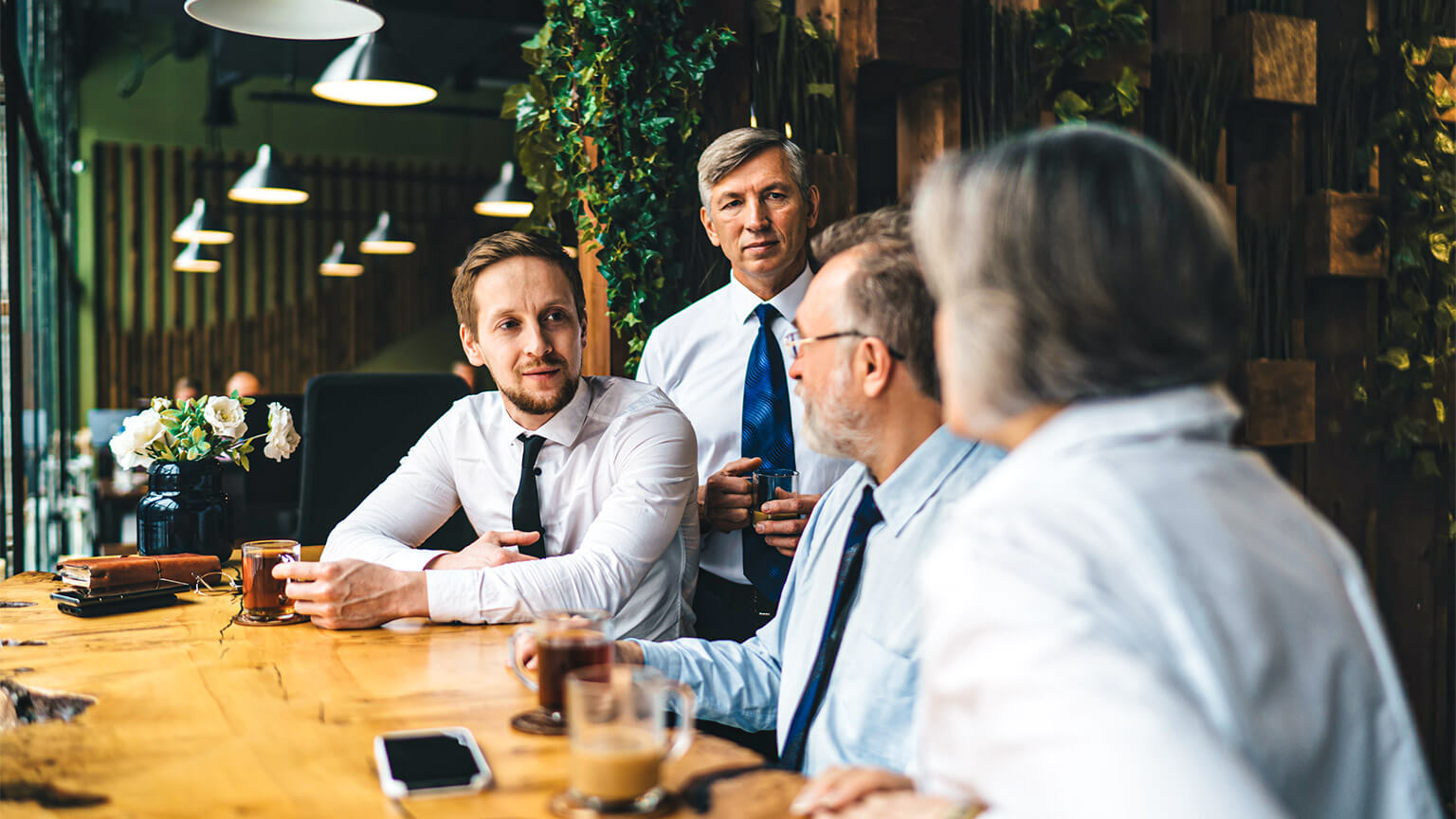 Members of a Human Resources Team discussing the implications of their organisation's global expansion