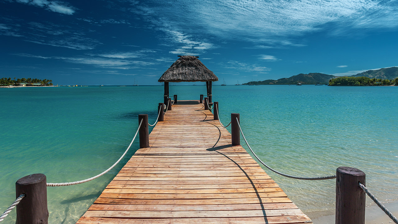 Warf over a blue green ocean in the tropics