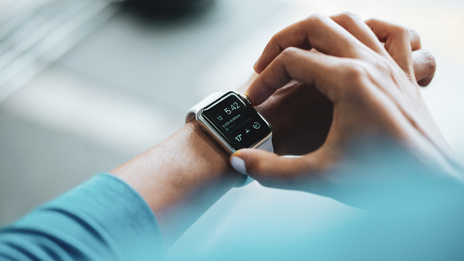 A person interacting with the interface of a smart watch