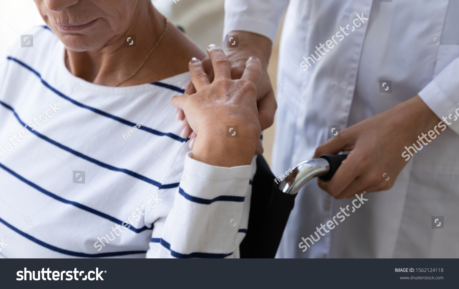 Person in wheelchair with someone holding shoulder