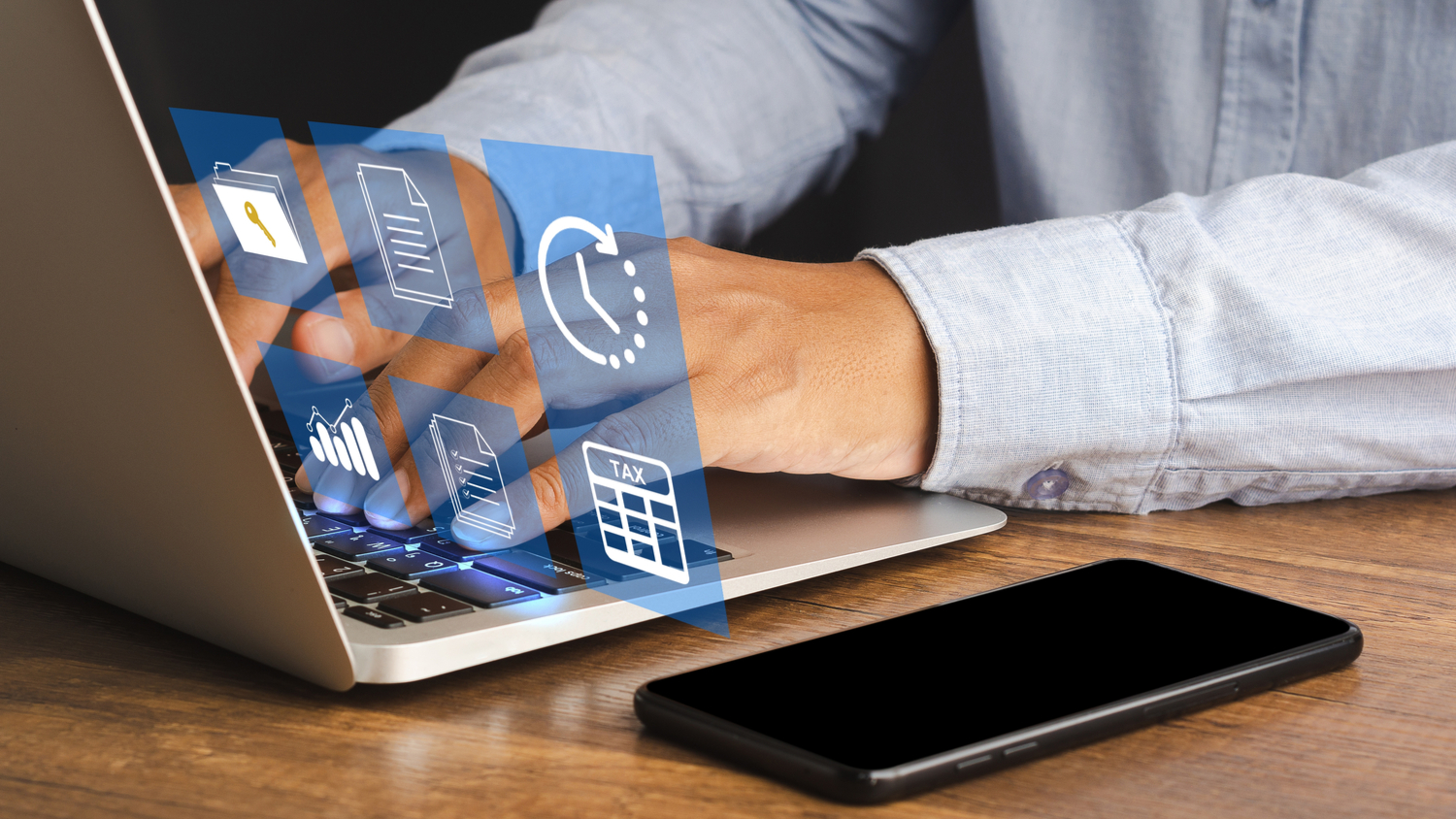 Businessman using a laptop to access payroll details. 