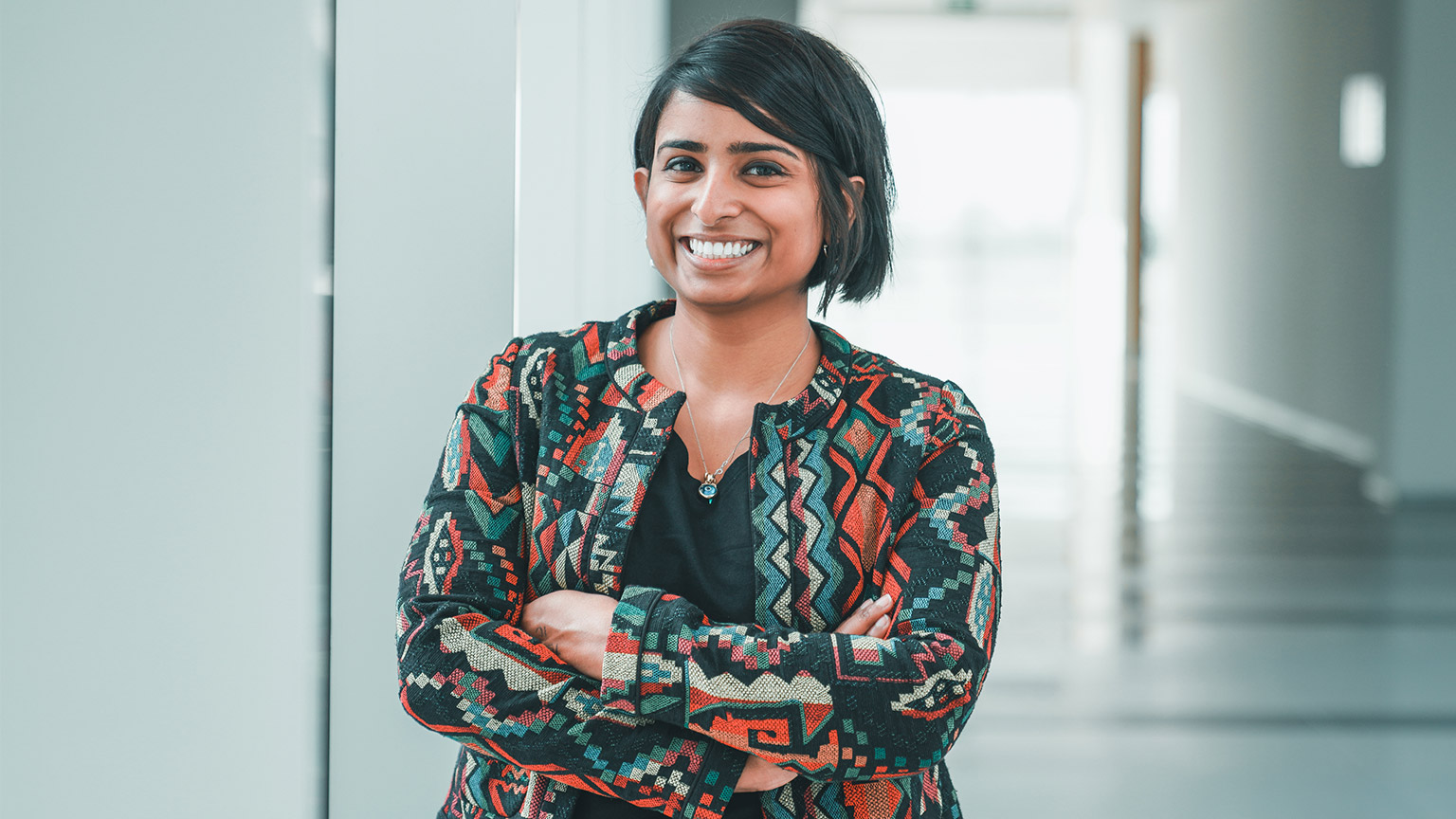 A smiling accountant about to start working on a spreadsheet