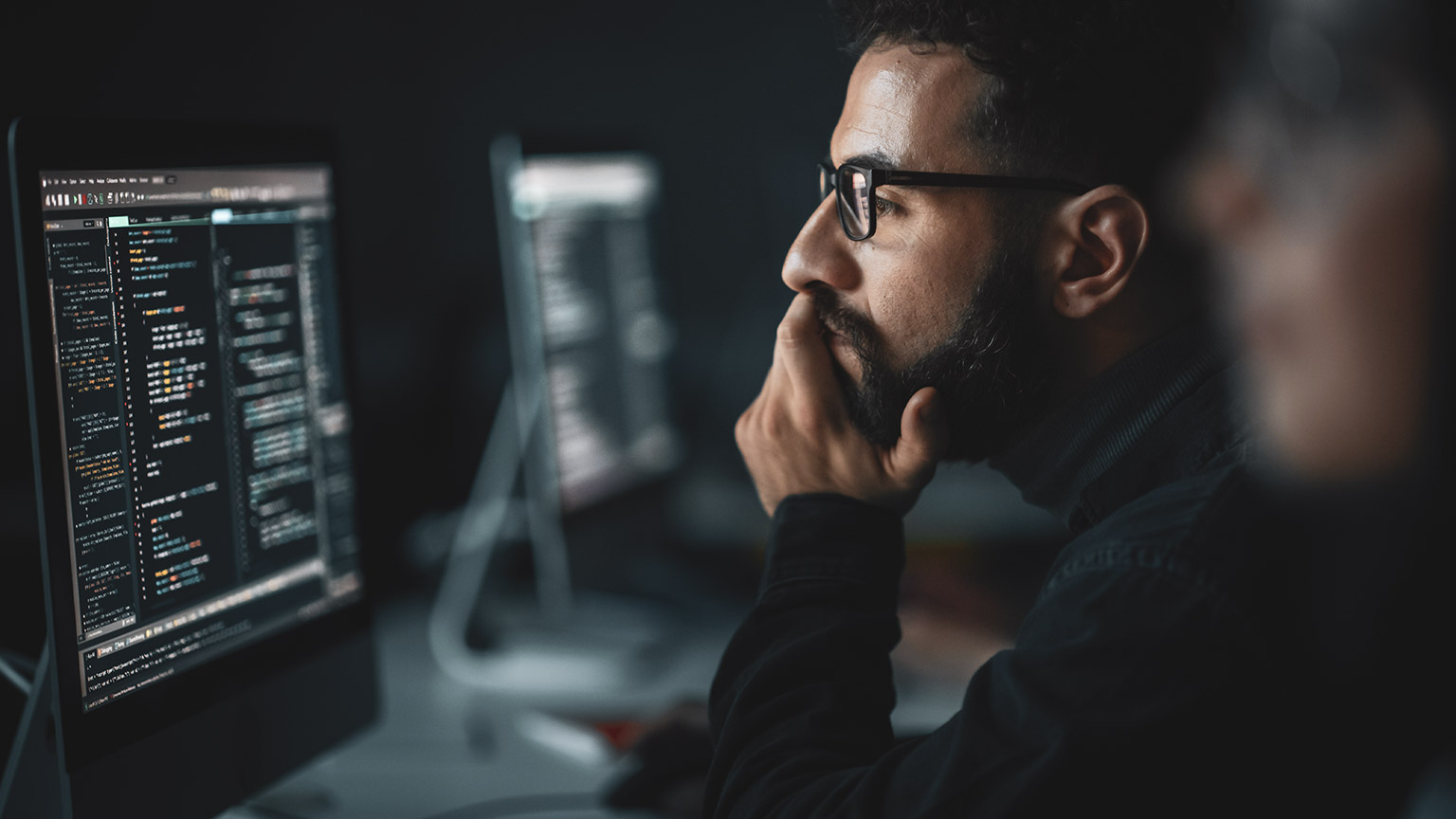 A programmer staring at a screen of code and hoping everything is correct