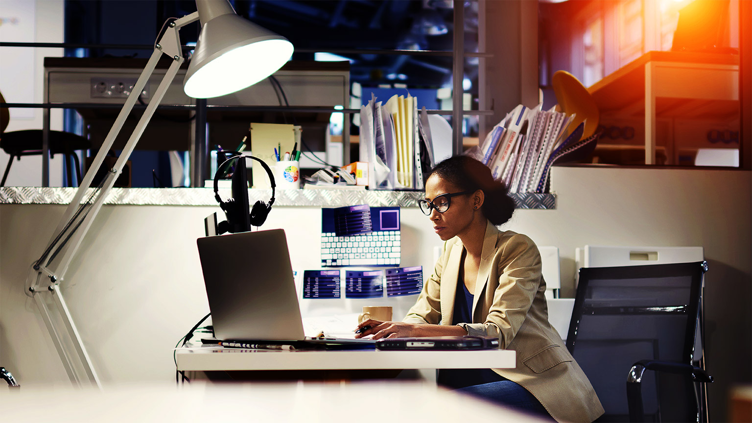 A professional seated at their desk, focusing on a major project they've been awarded