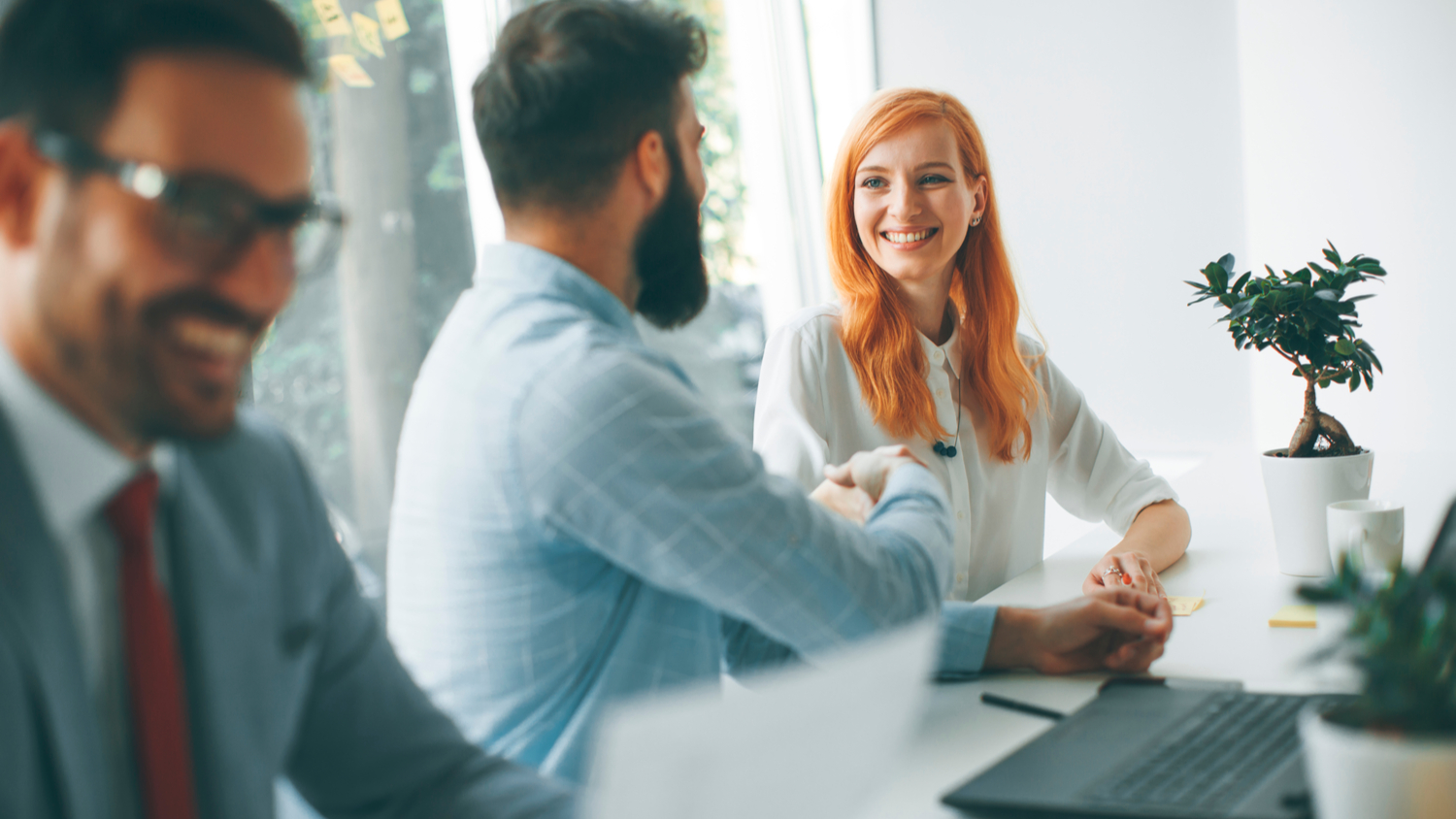 Two business workers talking at a desk