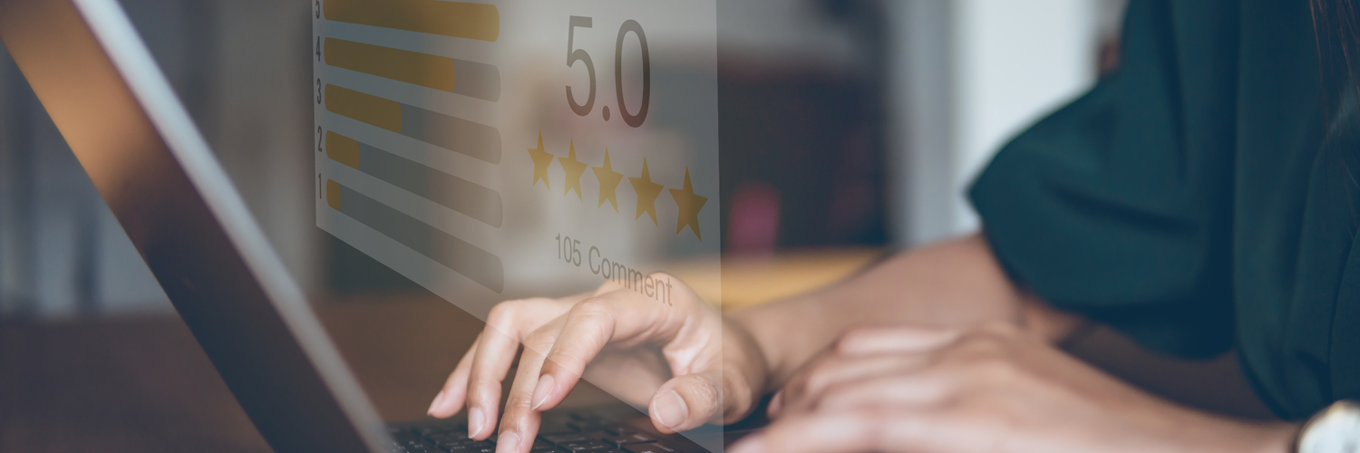 Person on a laptop with icons of star ratings