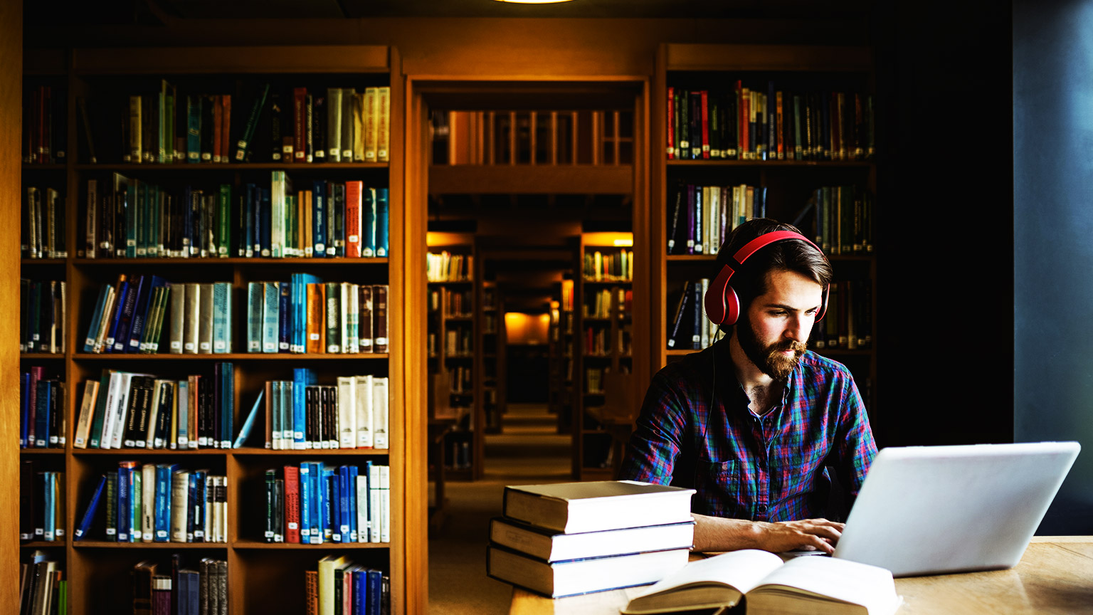 A student recording their references after spending time researching in the library