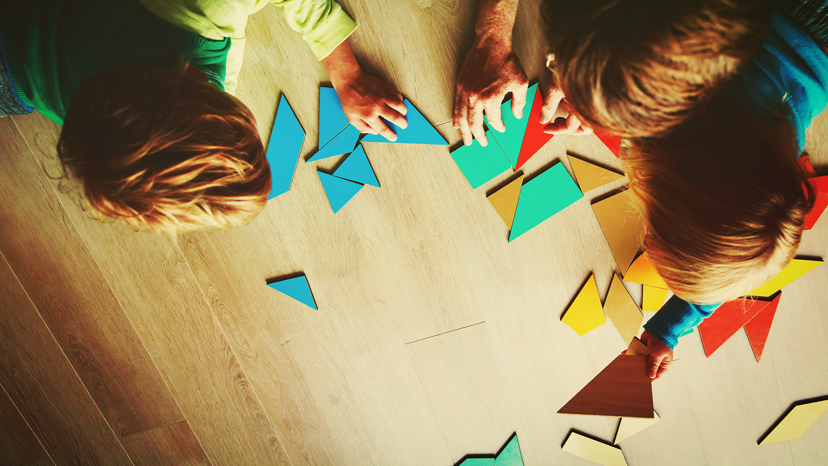 an educator and a couple of students solving a puzzle together