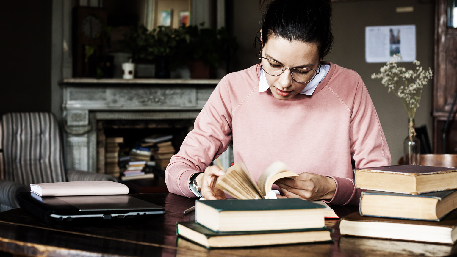 a person reading and on a laptop computer